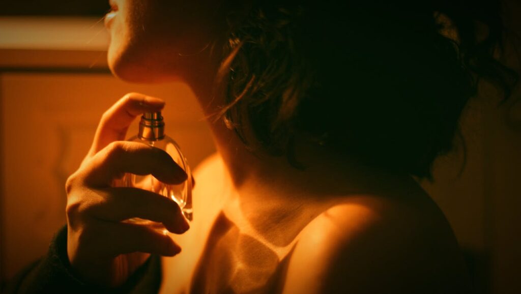 woman putting on perfume